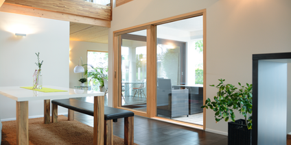 Modern interior with dining table and Lift&Slide sash with panoramic glazing